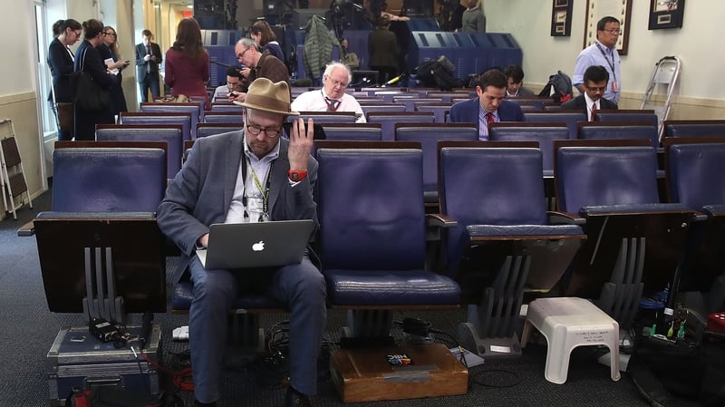 New York Times reporter Glenn Thrush works in the Brady Briefing Room after being excluded from a press briefing by White House Press Secretary Sean Spicer