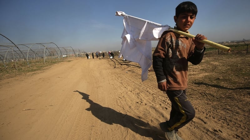 A displaced Iraqi boy from the Dindan neighbourhood in Mosul carries a white flag as he flees towards the Hammam al-Alil area