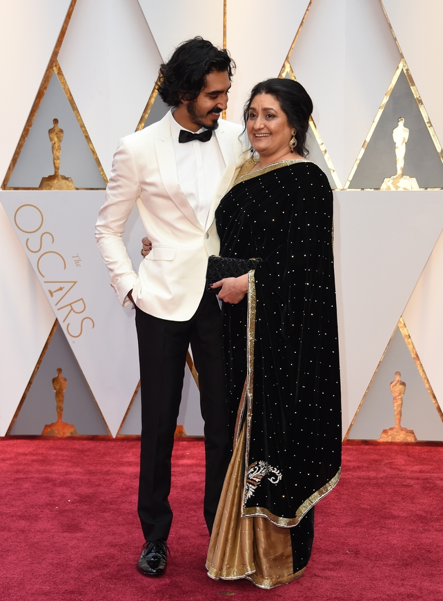 Dev Patel and his mother Anita! Dev looks so handsome in custom white Burberry.