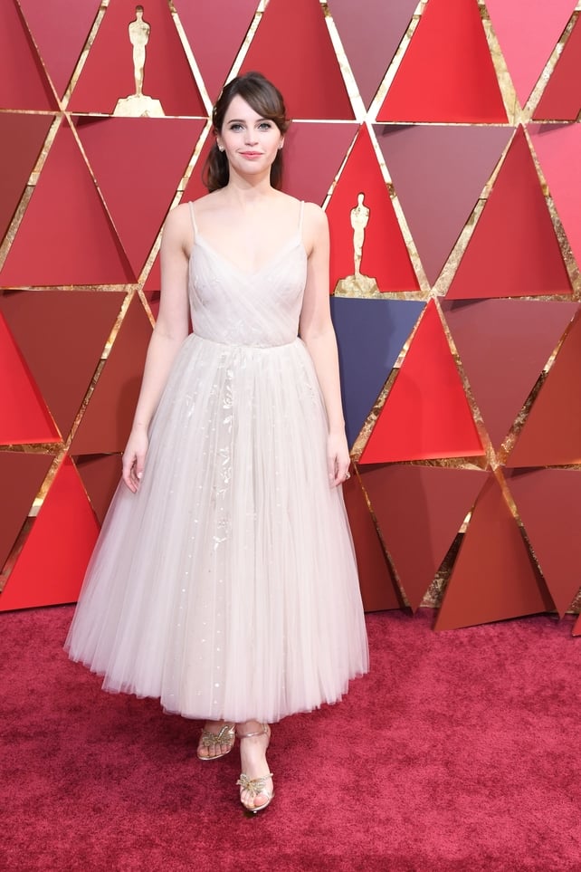 Felicity Jones looks like a ballerina in this pale Dior dress, Christian Louboutin shoes, and Niwaka jewelry.