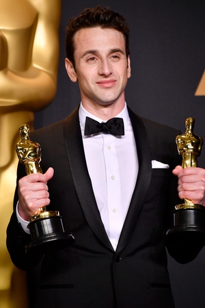 Composer Justin Hurwitz holds his two Oscars for the music behind La La Land