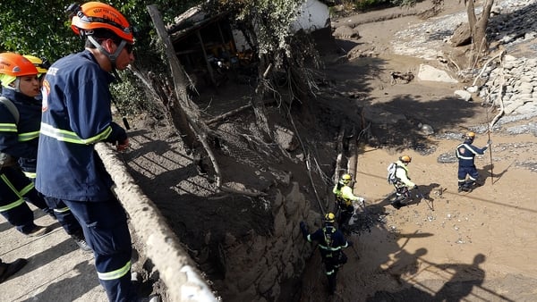 Rescue workers search for survivors of the floods