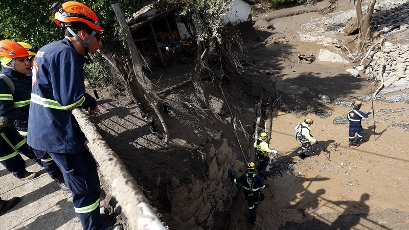 Rescue workers search for survivors of the floods