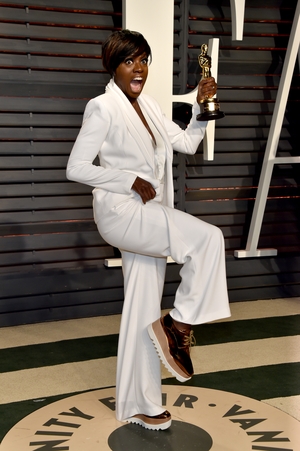 Oscar winner Viola Davis celebrated her award with a stunning white suit and golden platform runners.