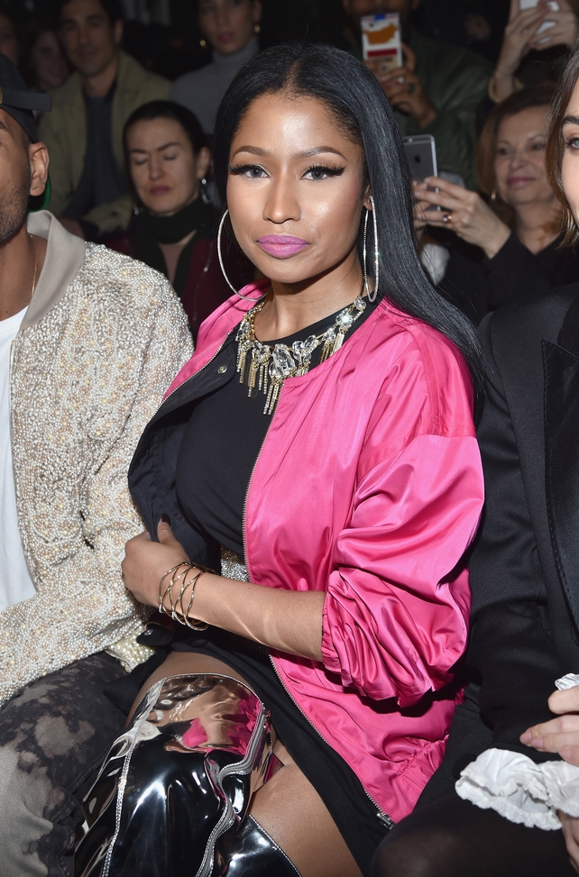 Singer Nicki Minaj in silver thigh boots attending the H&M Studio Fashion Show.