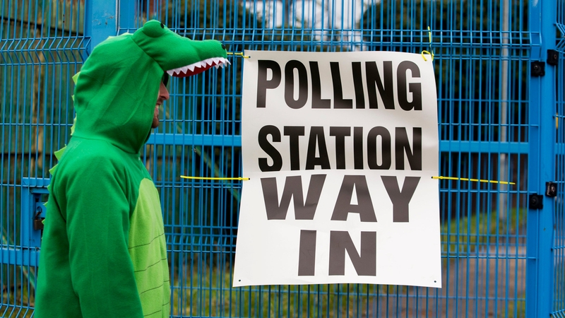 A Irish language activist dressed in a crocodile costume make his way to a polling station. Arlene Foster opposed an Irish Language Act in the North by saying 'If you feed a crocodile they're going to keep coming back and looking for more'