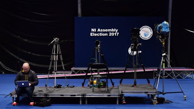 A man works on his laptop as the election count takes place at the Titanic Exhibition Centre