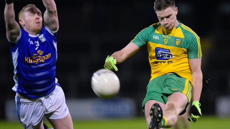Ciaran Thompson scores despite the efforts of Cavan's Cian Mackey