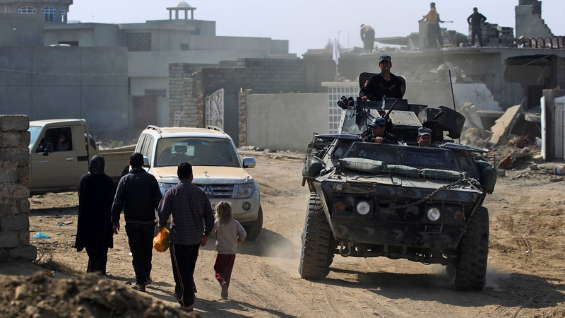 Iraqi forces patrol a street in Mosul during an offensive to retake the city from Islamic State fighters