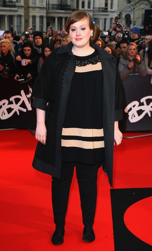 One of Adele's first red carpets at the Brit Awards in 2008, with her famous bun and simple striped dress.