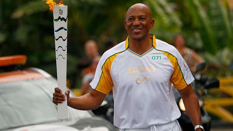 Frank Fredericks carrying the Olympic torch in Brazil last year