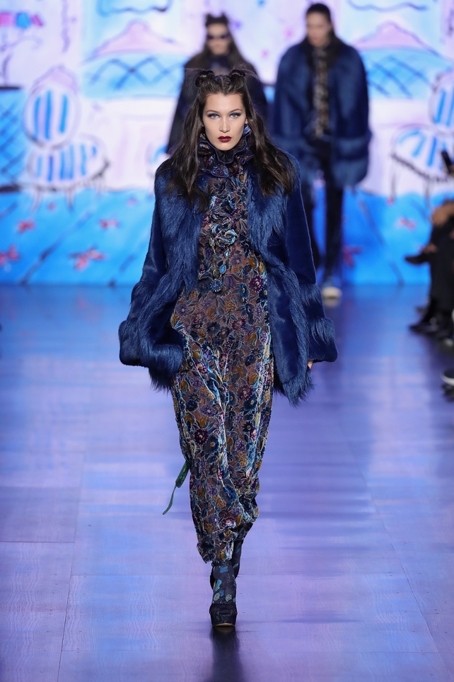 Bella at the Anna Sui New York Fashion Week Show this year wearing a maxi velvet floral dress and double bun hairstyle.