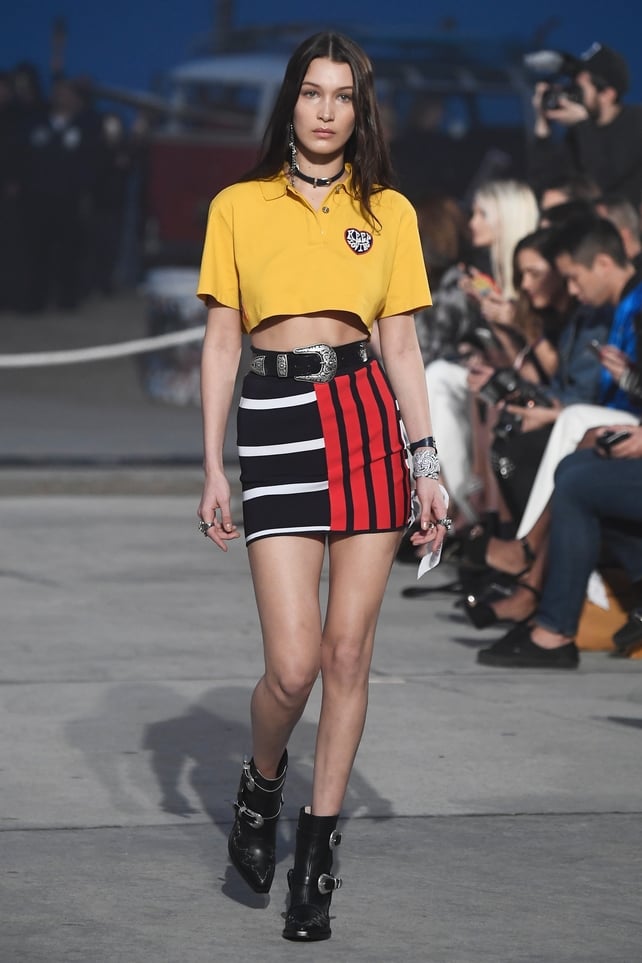 Bella proves that she's a real California Girl at the Tommy Hilfiger Fashion Show this year with cropped polo shirt and striped skirt!