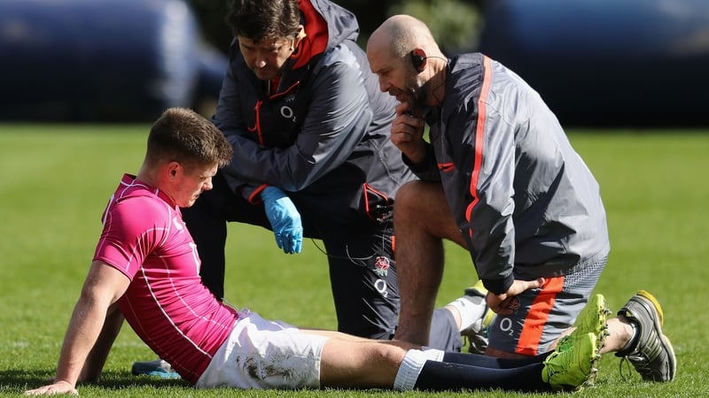 Owen Farrell receives treatment during training today