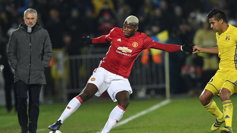 Jose Mourinho looks on as Paul Pogba controls the ball near the sideline in Russia
