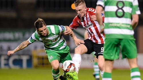 Ronan Curtis and Darren Meenan challenge for the ball