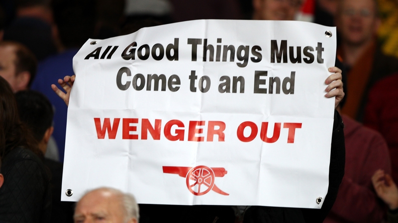 A disgruntled Arsenal holds up a banner urging manager Arsene Wenger to leave the club