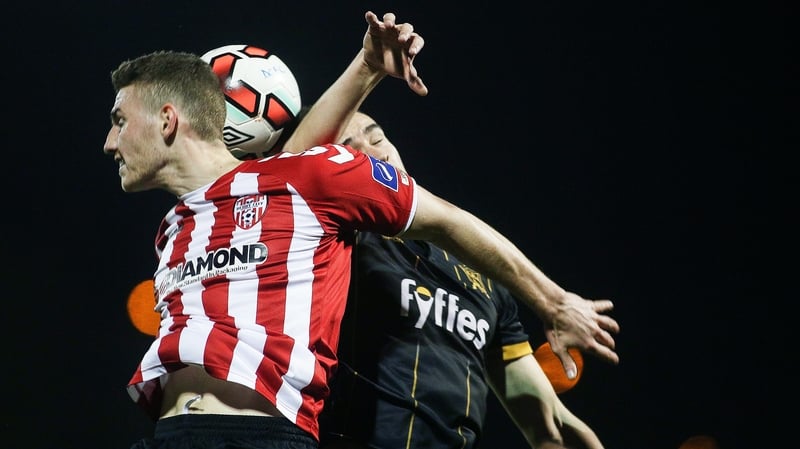 Derry's Harry Monaghan and Dundalk's Robbie Benson contest in the air