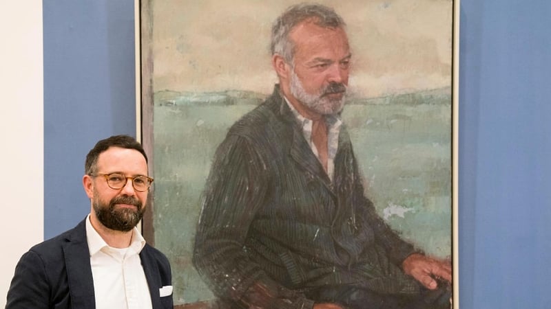 Gareth Reid with his portrait of Graham Norton
