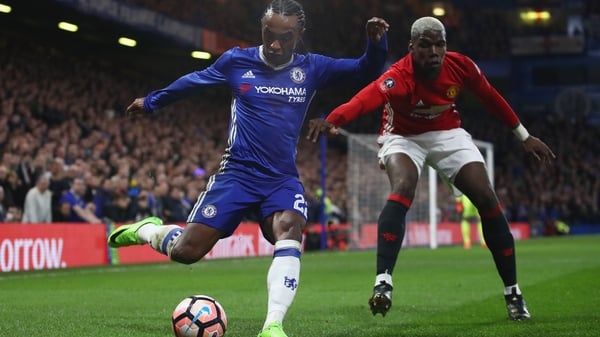 Paul Pogba (R) closes down Chelsea's Willian