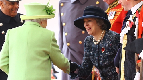 Queen Elizabeth shakes hands with Theresa May at an event last year
