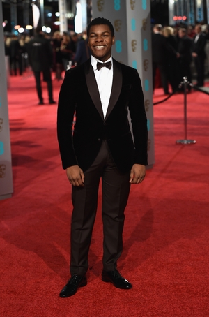 Charming John Boyega all smiles at the British Academy Film Awards in 2016. This velvet Armani suit just makes him look flawless!