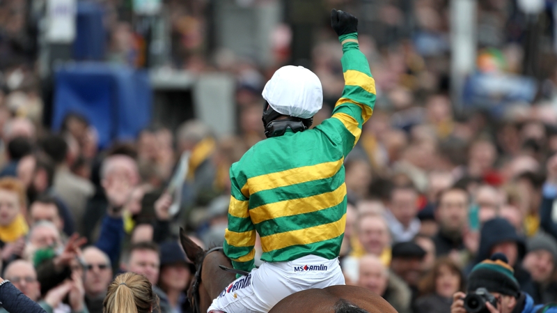 Jockey Richard Johnson celebrates after his winning ride on Defi Du Seuil