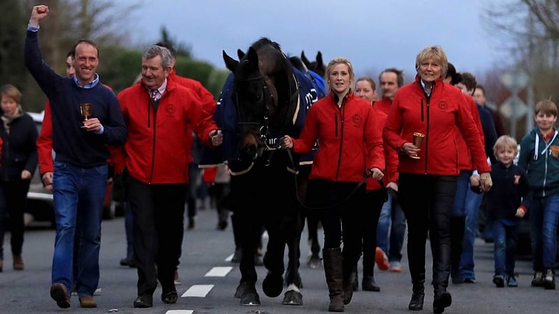 Sizing John Sizing John is led into Moone Village with jockey Robbie Power, head lad Eamonn Leigh, groom Ashley Hussey and trainer Jessica Harrington