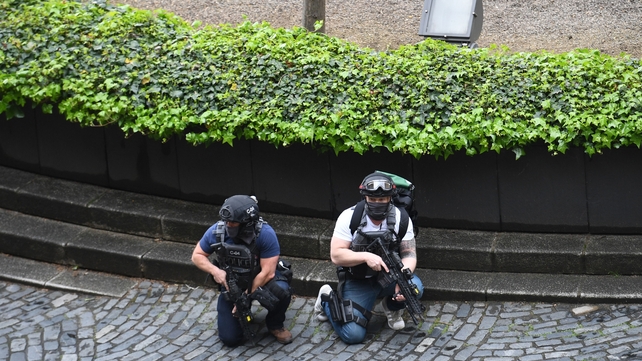 Armed police crouch outside the Palace of Westminster