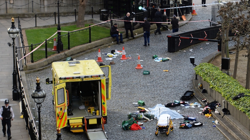 A body is covered by a sheet outside the Palace of Westminster
