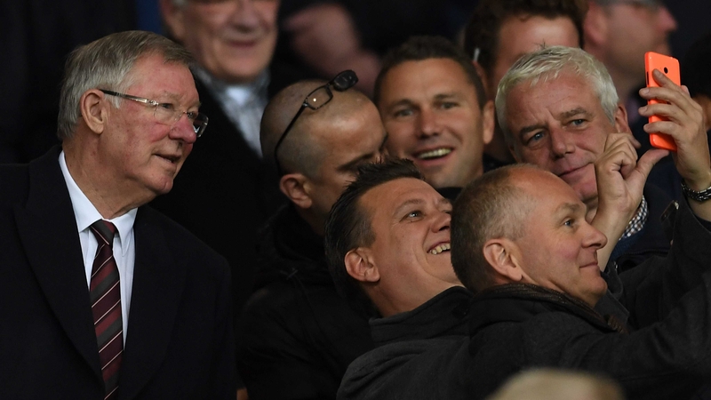Alex Ferguson poses for a selfie during a Europa League tie at Old Trafford