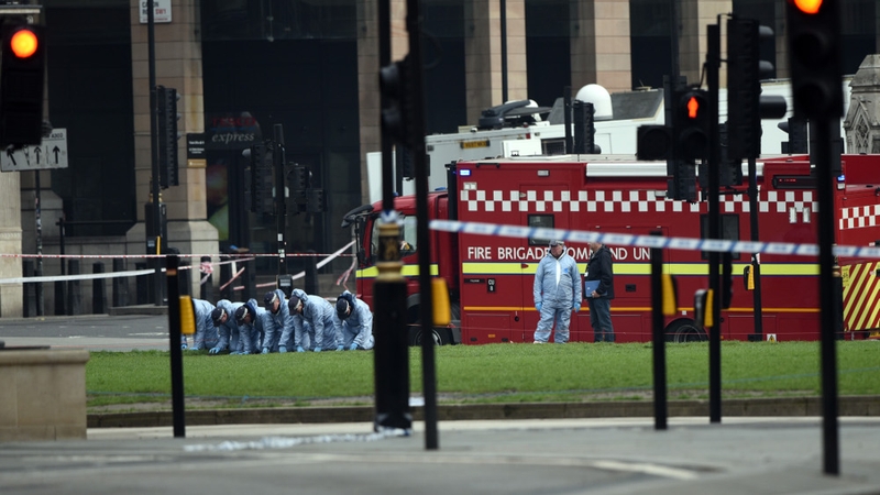 Police forensic officers work in Parliament Square following yesterday's attack