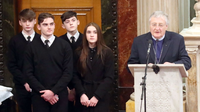 Rev Harold Good speaks while Martin McGuinness's grandchildren look on behind