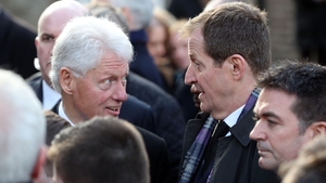 Former US president Bill Clinton speaks to Alastair Campbell after the funeral mass for Martin McGuinness