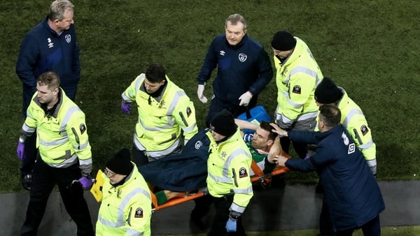 Seamus Coleman is comforted by assistant manger Roy Keane