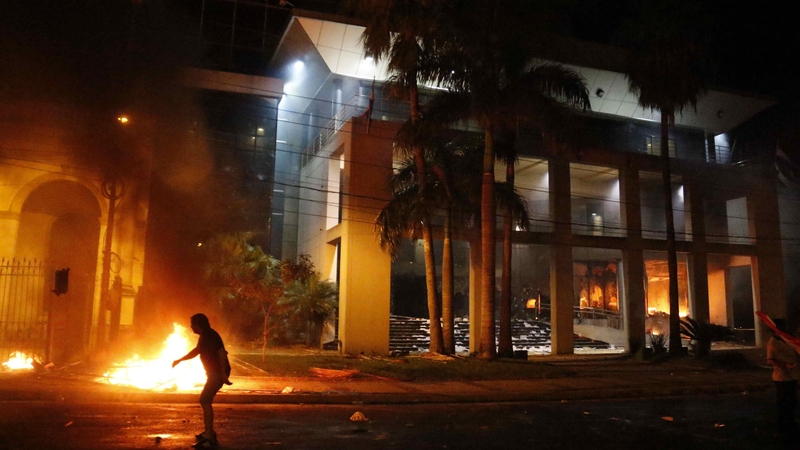 Fire burns after protesters stormed the National Congress in Asuncion in Paraguay