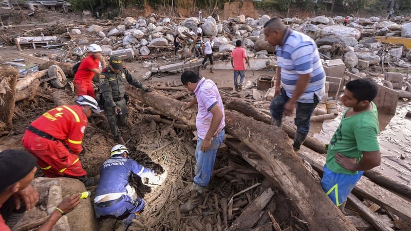 Rescuers search for people among the rubble left by mudslides following heavy rains in Mocoa