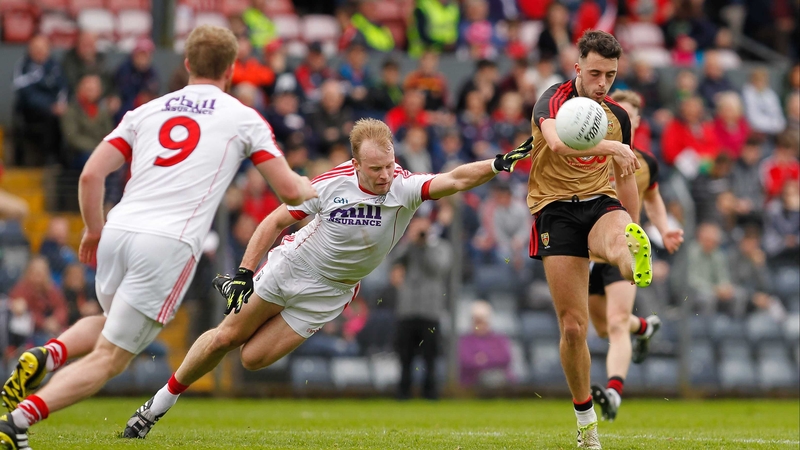 Down's Ryan Johnston gets a shot away despite the attentions of Michael Shields