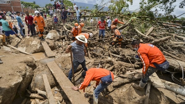 Rescuers search for victims following the mudslides caused by heavy rains in Mocoa