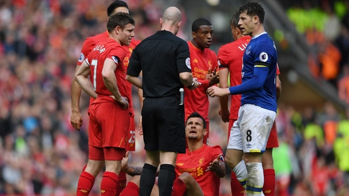 Lovren lies on the ground and appeals to referee Anthony Taylor after a foul by Barkley (r)