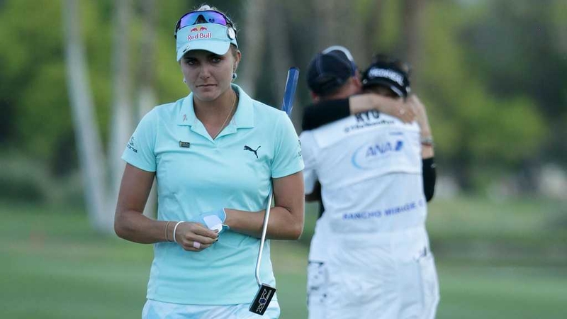 Lexi Thompson walks off the 18th green as So Yeon Ryu celebrates her play-off win