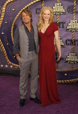 Nicole and husband Keith Urban attend the 2008 CMT Awards. Nicole wore a red Yves Saint Laurent Pre-Fall gown with braided detail.