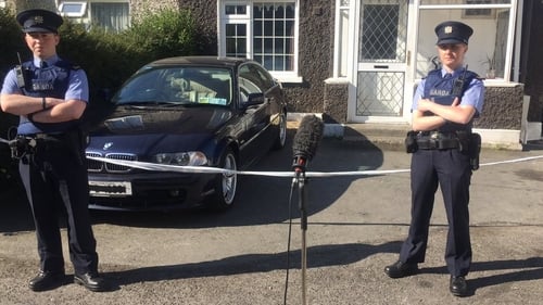 A gunman wounded the woman when she opened the door of her house
