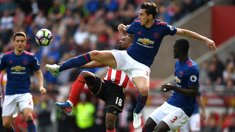 Matteo Darmian gets there ahead of Jermain Defoe