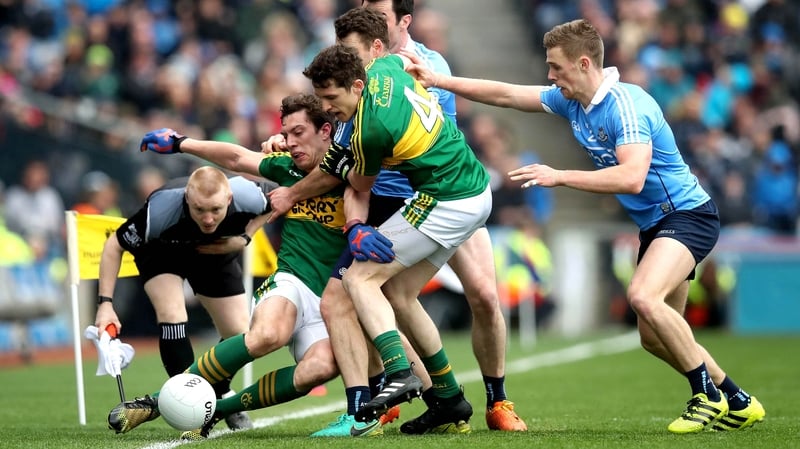 Kerry and Dublin players tussle along the sideline at Croke Park