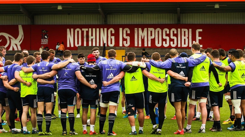 Munster players huddle together after training