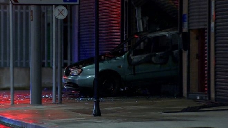 A car was reversed through the shutters of the business