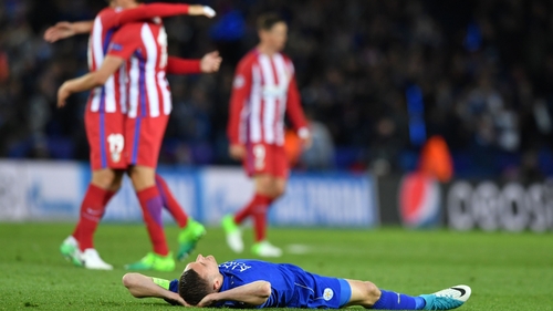 A dejected Jamie Vardy lays on the pitch following the defeat to Atletico Madrid