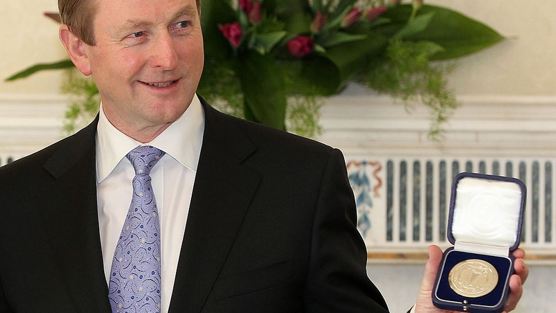 Enda Kenny poses with his new seal of office at Áras an Uachtaráin on 9 March 2011