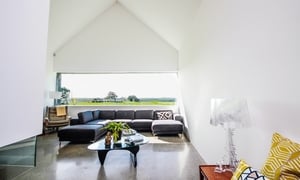 The living area is home to high ceilings and a suspended fireplace.
